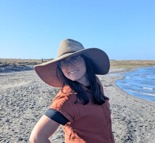 Shannon, your holistic health coach, outdoors at the beach.